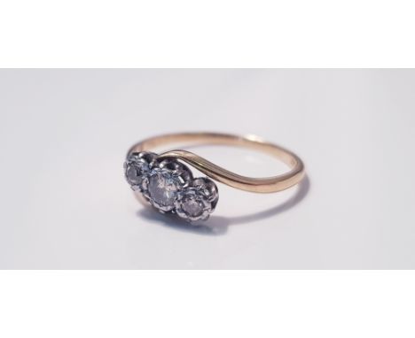 A yellow gold three stone diamond ring on twist, marked 18ct, ring size P1/2, approx. weight 1.49gms. IMPORTANT: Online viewi