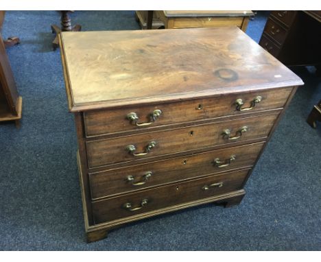 A small mahogany 19th century four drawer chest on bracket feet. IMPORTANT: Online viewing and bidding only. Collection by ap
