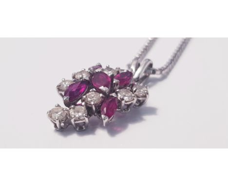 A ruby and diamond cluster pendant marked 750, on a chain marked 9k, approx. length of chain 15", approx. weight with pendant