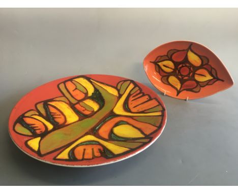 Poole Pottery charger in red orange and green, diameter 41cm, with Poole Pottery dish in orange, Red and yellow, length 30cm.