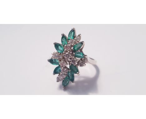 A white metal emerald and diamond dress ring, with twelve diamonds and ten emeralds, ring size L 1/2, approx. weight 7gms. IM