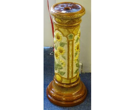 A vintage glazed pottery jardiniere stand, possibly for Burmantofts, decorated with colourful floral panels on brown ground, 