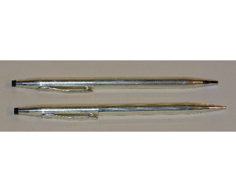 A boxed pair of silver Cross pens, of plain ribbed design, comprising roller ball and propelling pencil, stamped 'Sterling Si