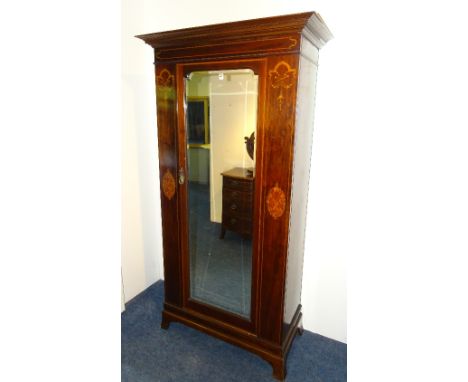 A Sheraton Revival mahogany inlaid single door wardrobe, circa early 20th century, with moulded cornice above glazed door, de