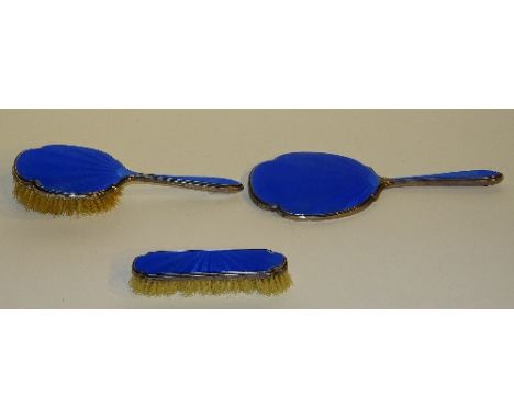 A silver and blue enamel backed brush set, hallmarks for Birmingham 1935 Walker & Hall, comprising of hairbrush, clothes brus