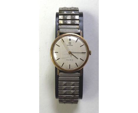 A vintage 1970's Omega gentleman's wristwatch, the white enamel dial with baton numerals, on steel elasticated strap, face 3.