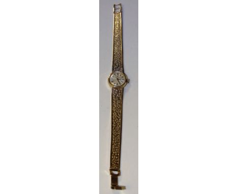 A 9ct gold lady's Omega watch, circa 1971, the white enamel dial with baton numerals, engraved to reverse, on gold bracelet s