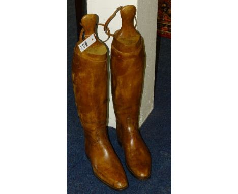 A pair of vintage brown leather hunting boots with trees, approx size 8/9 with narrow calf fit, 46cm high x 28cm toe to heel,