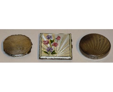 A lady's silver and enamel cigarette case, hallmarks for Birmingham 1950 HCD, the white enamel front decorated with purple sw