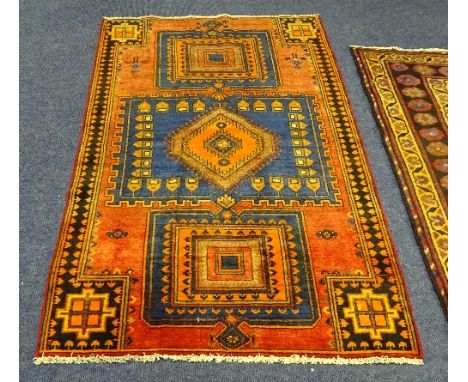 A small Hamadan rug, the three central orange diamond and square medallions on blue ground with red surround and black and or