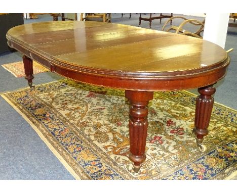 A Victorian style mahogany D-end dining table, with two additional leaves, with winder, raised on reeded turned columns and c