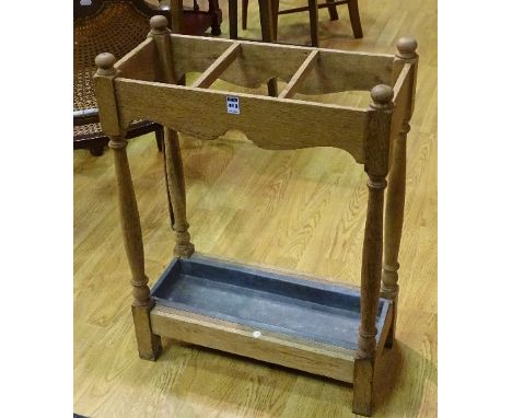An oak stick stand, raised on turned columns, with drip tray, 76cm high x 56.5cm wide x 26.5cm deep