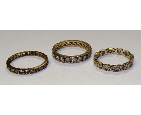 Three 9ct gold and paste eternity rings, stamped 9ct, ring size O & K, 5.9g (3)