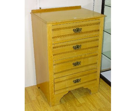 A light oak chest of drawers, with four drawers, 101cm high x 67.5cm wide x 49cm deep