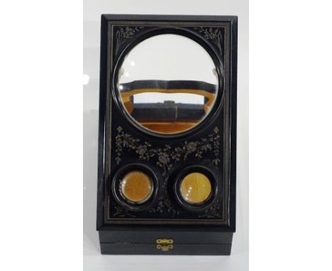 A Victorian ebonised table top stereo card viewer, with magnified panels to the front, raised on easel support, 26cm high x 2