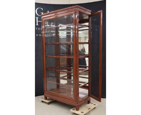 Modern Chinese hardwood glazed display cabinet,&nbsp;the glazed front panel and side hinged doors enclosing framed glass shel