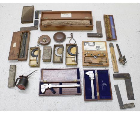 Wooden chest containing assorted cased tools including stocks and dies, micro measures, rulers etc. 