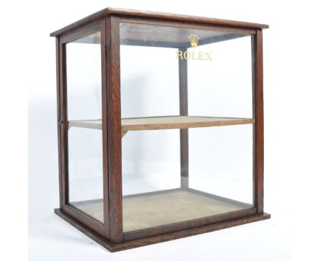 An original retro vintage mid-20th century shop countertop display advertising cabinet with ' Rolex ' notation to front. Oak 