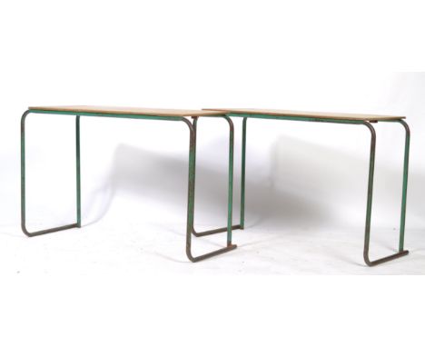 A pair of original 1950's retro vintage industrial / school work benches / tables / desks having wooden tops raised on green 