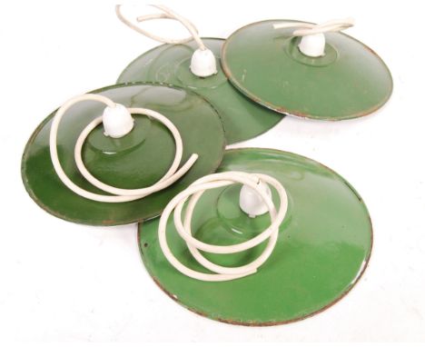 A collection of four 20th Century retro vintage industrial porcelain enamel UFO saucer pendant ceiling light shades in two to