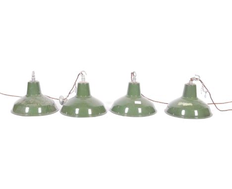 A set of four 20th Century retro vintage industrial porcelain enamel pendant lights having galvanized hanging hooks atop. The