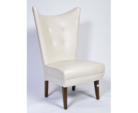 An original 20th Century retro vintage bedroom chair having a wingback back rest with four button back. Cushion seat and back