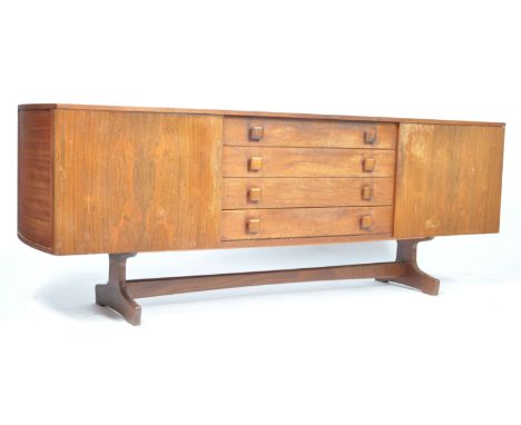 An unusual 1970's retro vintage teak wood sideboard credenza having a central bank of four drawers flanked by single door cup