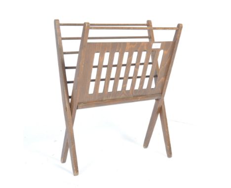 Lobeco - A 1960's Romanian retro vintage stained oak folding magazine rack having a pierced panel to one side and rails to th