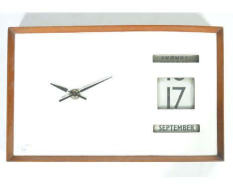 A mid to late 20th Century retro vintage wall clock and perpetual calendar with white laminate front, black hands and glazed 