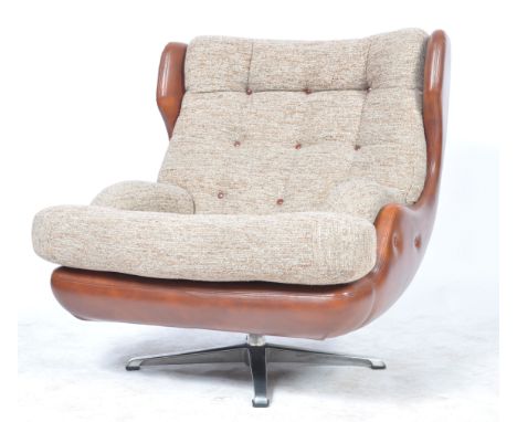 An original 1970's retro vintage wide swivel egg chair / armchair having a cushioned button backrest and seat in woolen uphol