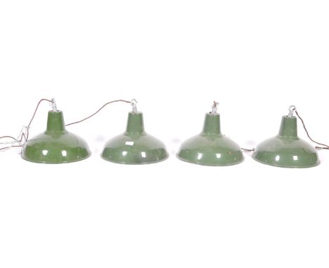 A set of four 20th Century retro vintage industrial porcelain enamel pendant lights having galvanized hanging hooks atop. The