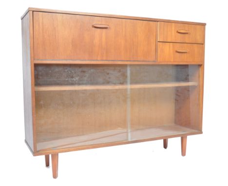 A 1960's retro vintage teak wood bureau glass display cabinet having a drop down door revealing a pigeon hole interior alongs