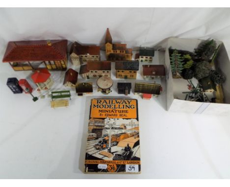Model Railways - A collection of German tinplate model railway building scenics and other comprising benches, bushes, trees, 
