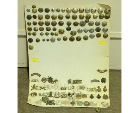 A collection of 117 military cap badges and buttons, including Royal Navy and Army, Egypt, and many others, mounted on large 