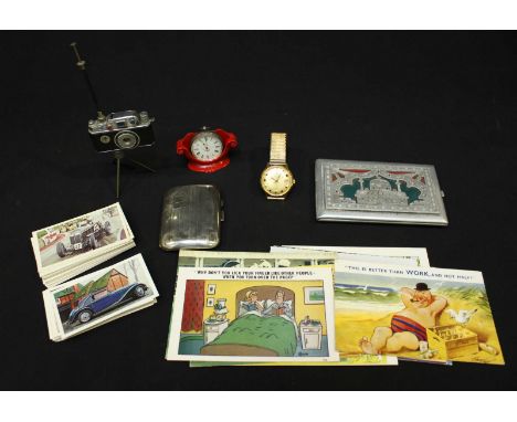 A collection of assorted items including a small silver cigarette box, 48 grams, a collection of cigarette cards and saucy po