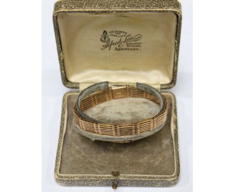 A 9ct gold seven bar gate bracelet, in a fitted box. 16.8 grams.