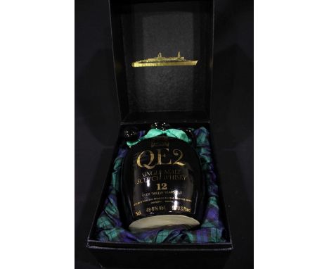 A boxed ceramic flagon of QE2 Single Malt Scotch Whiskey, over 12 years old.