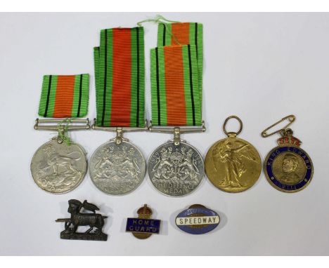 A group of assorted badges including a WWI Victory medal to 215243 Gunner R. Allen Royal Artillery, two WWII Defence medals a