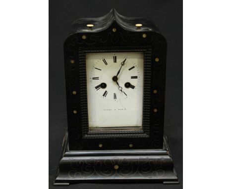 A 19th century ebonised mantel clock by Leroy of Paris, the white enamel dial with black Roman numerals, within an inlaid ebo