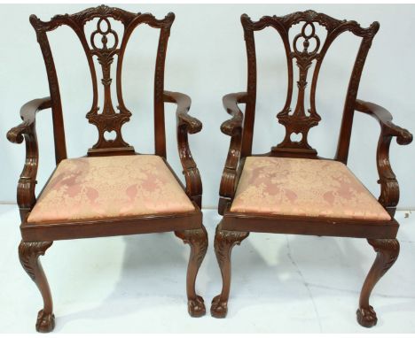 A good set of 12 reproduction dining chairs in the Chippendale "style," the backs with pierced splats, and serpentine crest r