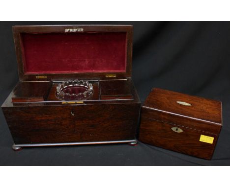 A 19th century Rosewood tea caddy of sarcophagus form, the hinged lid enclosing two removable lidded caddies and central glas