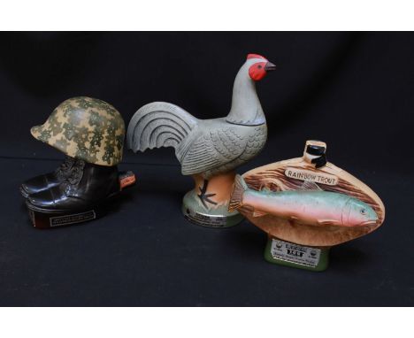 Three Regal China novelty Jim Beam whiskey decanters with contents, a Cockerel, a U.S. G.I. boots and helmet and a Rainbow Tr