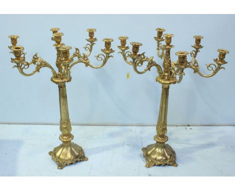 A pair of large modern gilt-brass seven-light candelabra, modeled in the rococo style with scrolling foliate decoration, 78cm