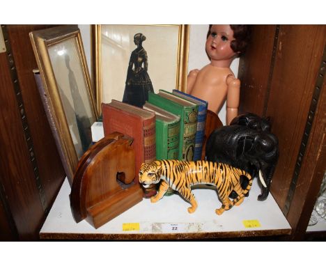 SECTION 22. A shelf of assorted items including a pair of Victorian silhouette costume portraits, wooden horses head book end