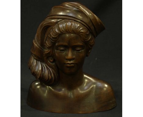 An Indonesian carved hardwood bust of a young lady wearing a head scarf. 26 cm high.