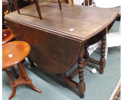 An oak drop leaf table with barley twist supports Condition Report: Available upon request