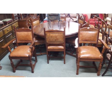 A reproduction circular dining table, 150cm diameter with six dining chairs and two carvers with leather seats and backs (9) 