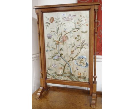 A walnut firescreen with woolwork inset Condition Report: Available upon request