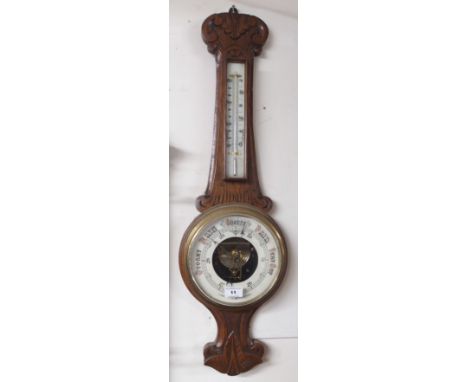 A carved oak barometer Condition Report: Available upon request