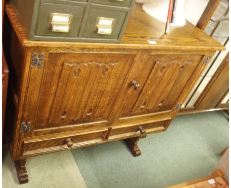 A carved oak buffet with two doors over two drawers, 95cm high x 107cm wide Condition Report: Available upon request